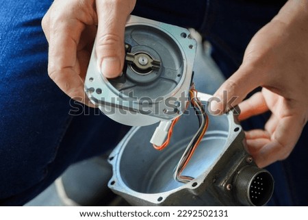 electric servo motor,Mechanic repairing AC servo motor, DC brush-less motor, and stepping motor in factory,electric servo motor cnc,close-up