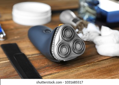 Electric shaver for man on wooden table - Shutterstock ID 1031685517