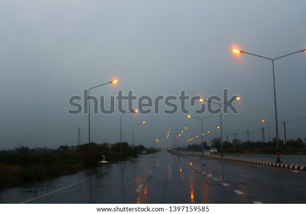 \
Electric shines on the road in the dark on\
a heavy rainy day, blurred\
photography