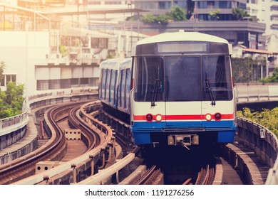 Electric Skytrain Is Running In Downtown Of Bangkok Metropolitan Region. It Is Running On Railroad Tracks.