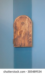 Electric Socket On The Blue Wall, Replica A Small Wooden Door From 