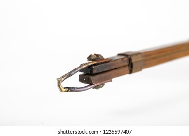 Electric Soldering Iron Finished With A Copper Arrowhead. Accessories For Electronics On A White Table. Light Background.