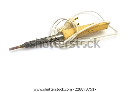 Electric soldering iron with wooden handle isolated on a white background.