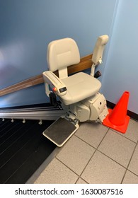 Electric Stair Chair Lift At Top Of Flight Of Stairs With Pylon