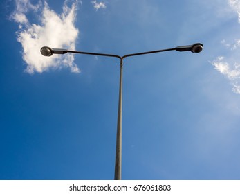 Electric street light pole on blue vivid sky in day light.