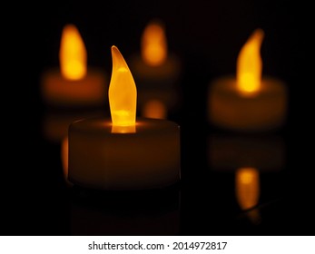 Electric Tea Candles In A Dark Room    