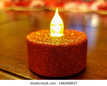 Electric Tea Light Candle Covered With Red Glitter Used On Valentine' Day.