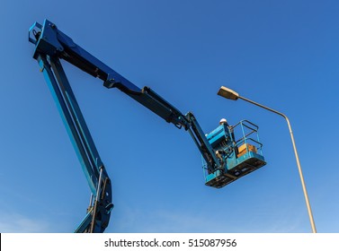 Electric Technical Repairing Street Light By Boom Lift In Industrial  