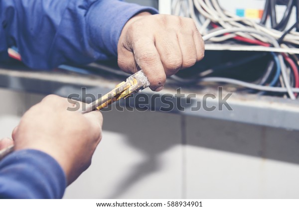 Electric technician fixing\
cable wire.