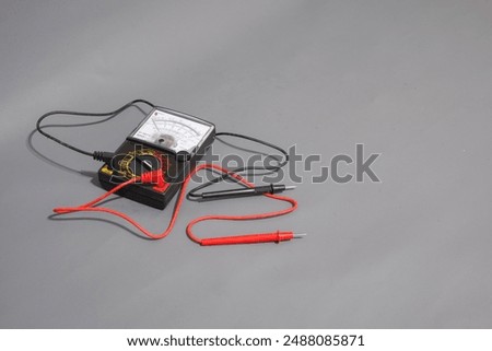 Electric tools. Multimeter analog or avometer analog with grey background. Tool for measuring electric current.