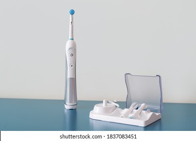 Electric toothbrush set. Modern rechargeable sonic or electric toothbrush set with charger. Concept of professional oral care and healthy teeth
