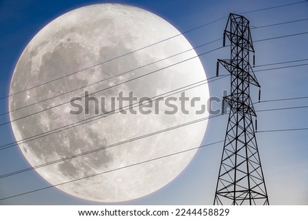 Electric tower with giant moon in the background. New sources of energy. Electric power transmission. Moon energy. Clean and renewable energy.