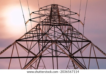 electric tower seen against the light