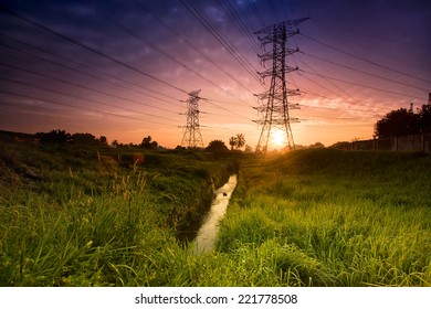 Electric tower at sunset with sun. 