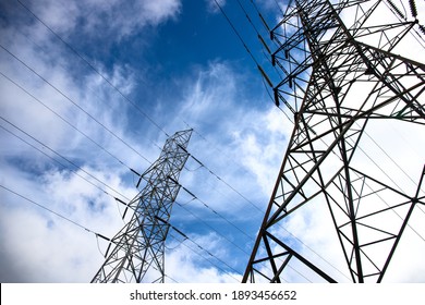 Electric Tower And Wires On Blue Sky. Telecommunication And Internet Provider Equipment. Communication Tower With Wire Line. Electrical Pylon View From Ground. Transmission Tower Skyscape