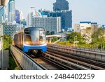 Electric train bright light railway carriage rushes turn travels along route in sunset sky railway road viaduct among the modern city of buildings, skyscrapers metropolis.