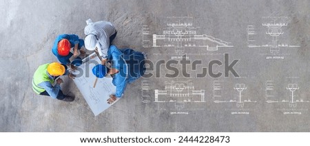 Electric Train Section drawing for construction, top view of architectural engineer working on his blueprints with documents on construction site. meeting, discussing,designing, planing	
