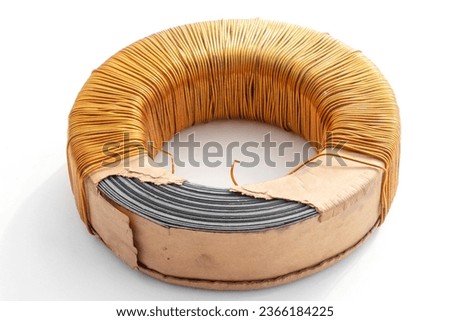 Electric transformer copper coil inductor on white background, close-up