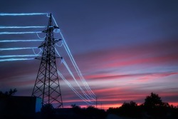 Electric Transmission Towers With Glowing Wires Against The Sunset Sky Background. High Voltage Electrical Pylons. Energy Concept.