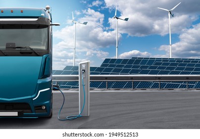 Electric Truck With Charging Station On A Background Of Solar Panels And Wind Turbines. Concept