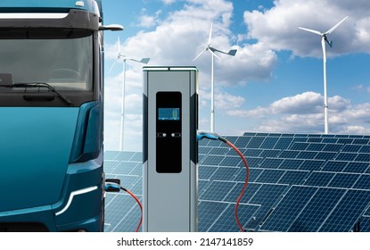 Electric Truck With Charging Station On A Background Of Solar Panels And Wind Turbines. Concept