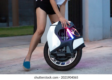 Electric Unicycle. Hand Of Woman Holding On Mono Wheel.