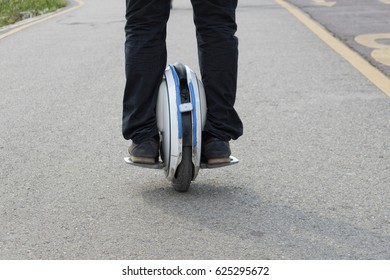 Electric Unicycle. A Man Rides On Mono Wheel