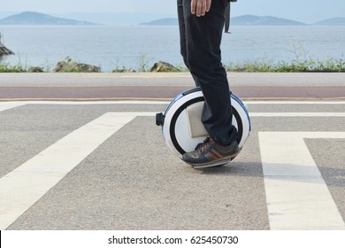 Electric Unicycle. A Man Rides On Mono Wheel