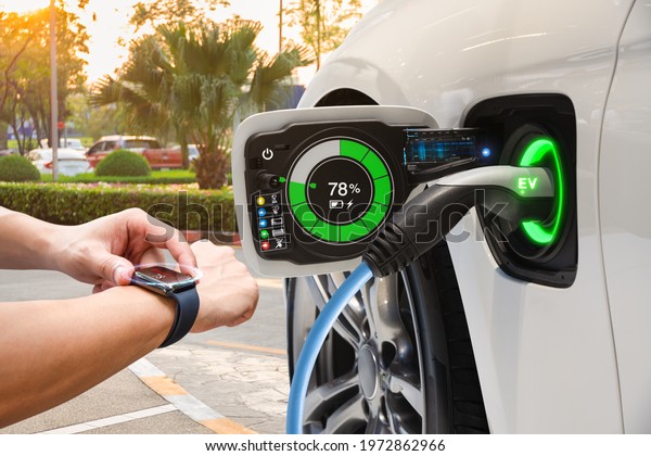 Electric vehicle changing on street parking with
graphical user interface synchronize with smart watch, Future EV
car concept