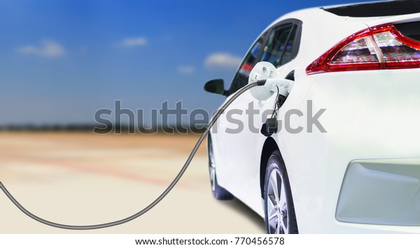 Electric vehicle charging,\
Charging an electric car in residential garage, Future of\
transportation