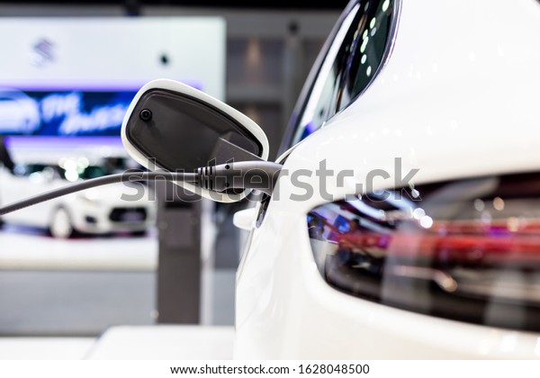 Electric vehicle charging station for home\
with EV car background