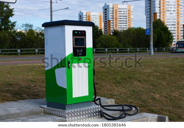 Electric vehicle charging\
station with power plug for electric vehicles. NFC payment. Smart\
energy. The concept of ecology and environmental pollution by car\
emissions.