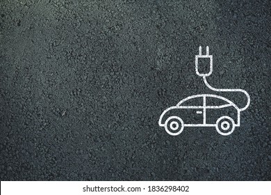 Electric Vehicle Charging Station Sign On Asphalt Background.