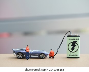 Electric vehicle concept. Unfocus mini toys on the table with blurred background. - Shutterstock ID 2141045163
