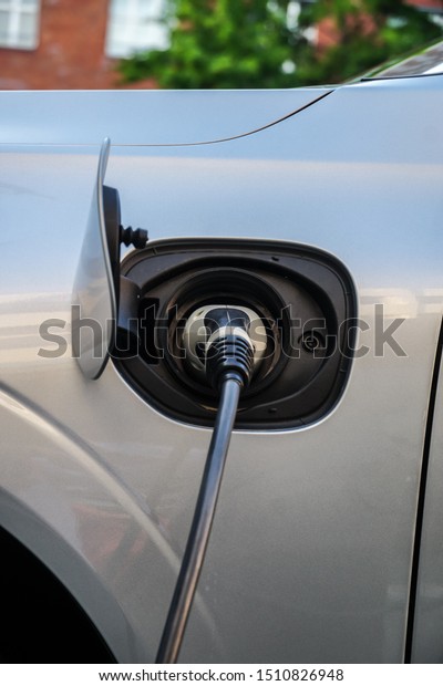 Electric vehicle plugged in\
charging