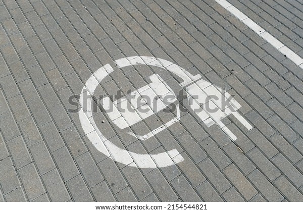 Electric vehicle\
symbol painted in parking\
lot.