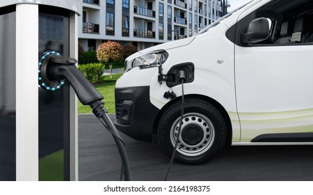 Electric Vehicles Charging Station On A Background Of Delivery Van. Concept