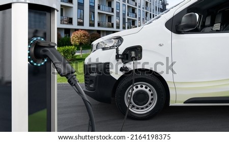 Electric vehicles charging station on a background of delivery van. Concept
