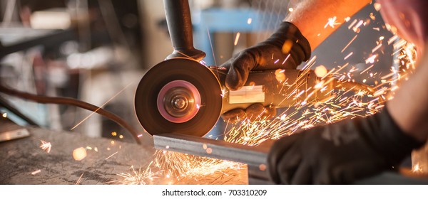 Electric wheel grinding on steel structure in factory. Sparks from the grinding wheel - Powered by Shutterstock