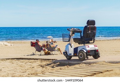Electric wheelchair on the beach background the sea