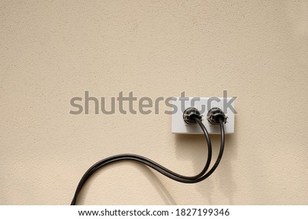 Electric wire plug Receptacle on the concrete wall background
