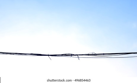 Electric Wire And Skies Gradient Blue Fade To White Background.