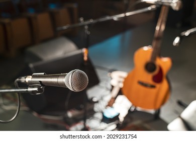 electric wired microphone on an empty stage without musicians. musical equipment for performing on stage before the concert