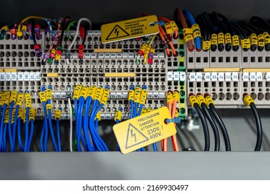 Electric wiring diagram of machinery in industrial factory. Terminal diagram with tag and warning label. High voltage electric wire. Automation machinery control panel. Electrical control cabinet. - Shutterstock ID 2169930497