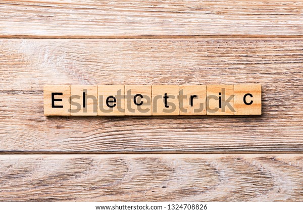 Electric word written on wood block.\
Electric text on wooden table for your desing,\
concept.