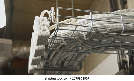 Electrical Box Power Cables And Telecommunication Wiring Tied In Basket Hanging Under Ceiling In Residential Building Basement