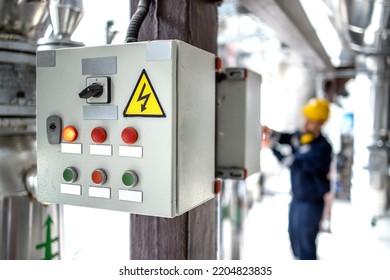 Electrical Cabinet And Engineer Operating Inside Power Plant.