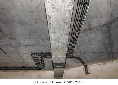 Electrical cable installation in a house under construction on a concrete ceiling.
