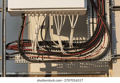 electrical cable management system, within an outdoor telecommunications or industrial cabinet. Industrial electric outdoors cabinet with wires , metal shield box with column