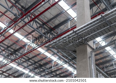 Electrical cable tray for cable routing between electrical distribution panel with equipment at bottom of upper floor. Selective focus.